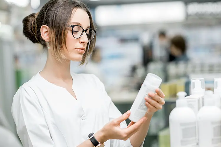 Woman reading cosmetic label ingredients checking